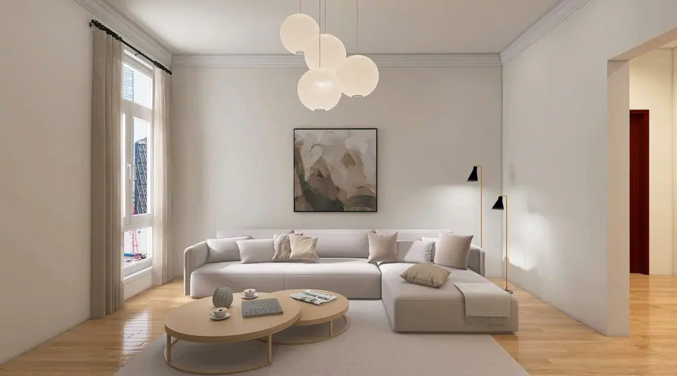 Açık gri kanepe, küre sarkıt lambalar ve boş duvarlarla sade minimalist oturma odası